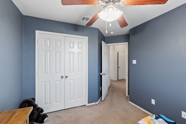 carpeted bedroom with ceiling fan and a closet