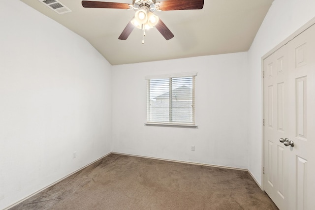 carpeted spare room with ceiling fan