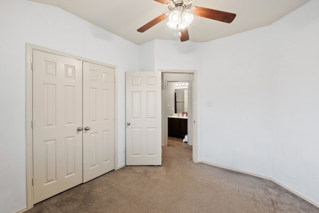 unfurnished bedroom with light colored carpet, a closet, and ceiling fan