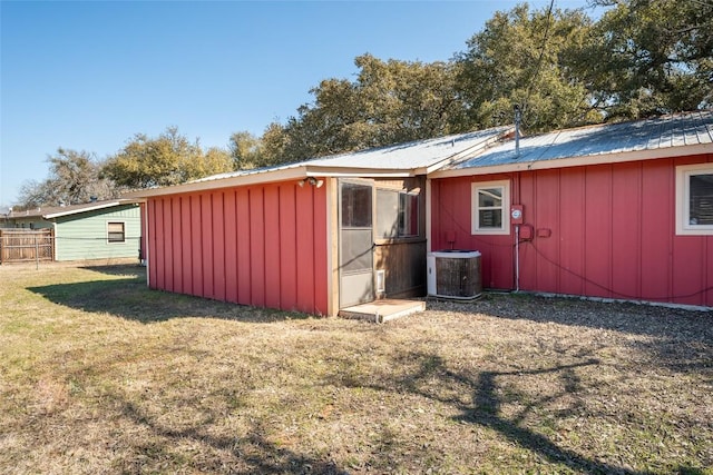 view of outdoor structure featuring a yard and central AC unit