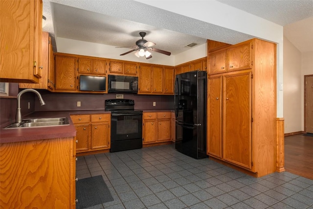 kitchen featuring light tile patterned flooring, sink, ceiling fan, black appliances, and a textured ceiling