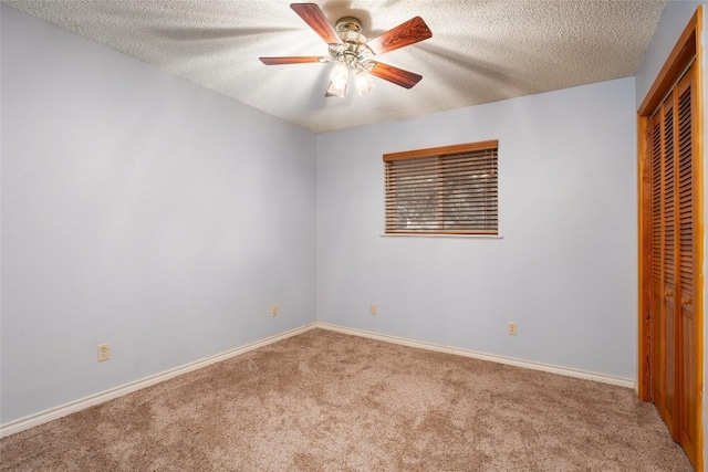 unfurnished bedroom with ceiling fan, carpet floors, a textured ceiling, and a closet