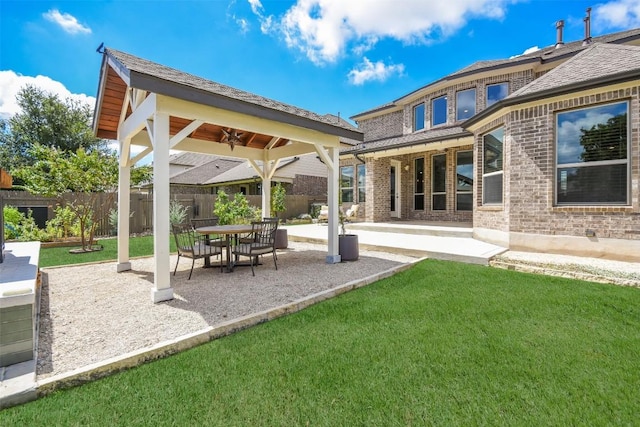 exterior space with a lawn, ceiling fan, and a patio area