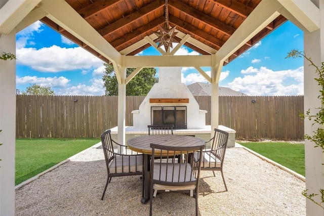 view of patio with a gazebo and a fireplace