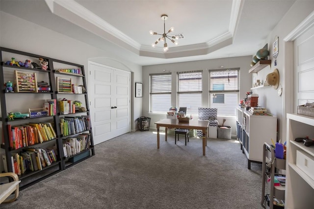 carpeted office space with ornamental molding, a raised ceiling, and a chandelier