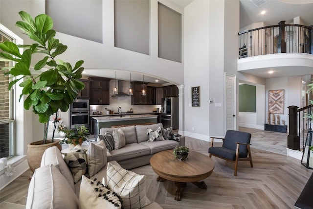 living room featuring sink and light parquet flooring