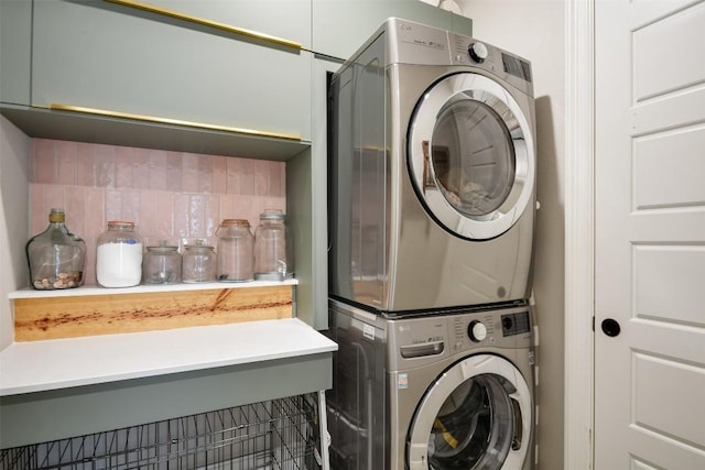 laundry room featuring stacked washer / drying machine