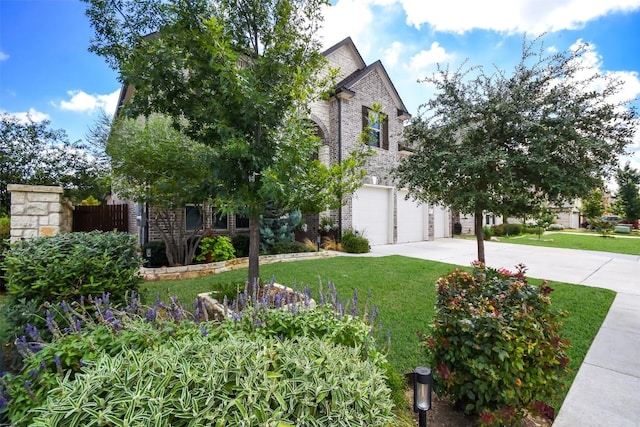 obstructed view of property with a garage and a front lawn