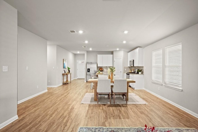 dining space featuring light wood-type flooring