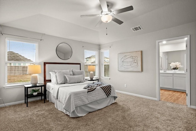 carpeted bedroom with connected bathroom and ceiling fan