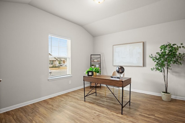 office space featuring vaulted ceiling and light hardwood / wood-style floors