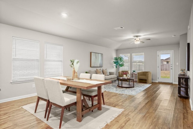 dining area with vaulted ceiling, light hardwood / wood-style floors, and ceiling fan