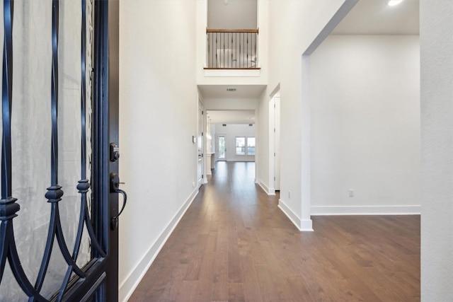 entryway with dark hardwood / wood-style flooring