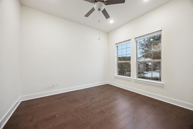 spare room with dark hardwood / wood-style floors and ceiling fan