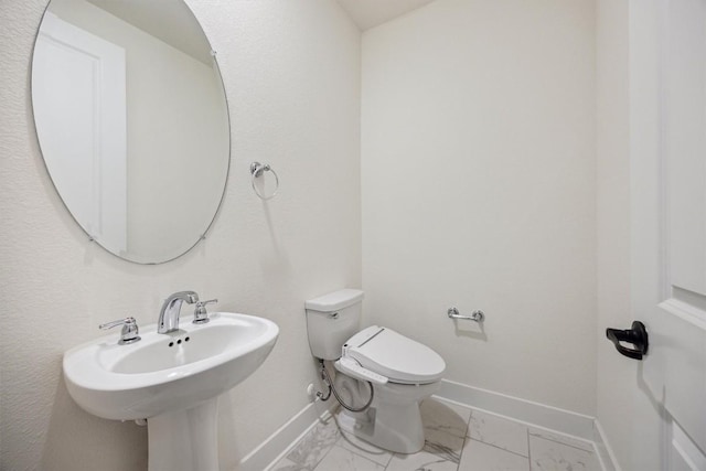 1220 Brassano Pl, Leander, TX 78641 - half bath featuring marble look tile flooring, baseboards, and toilet