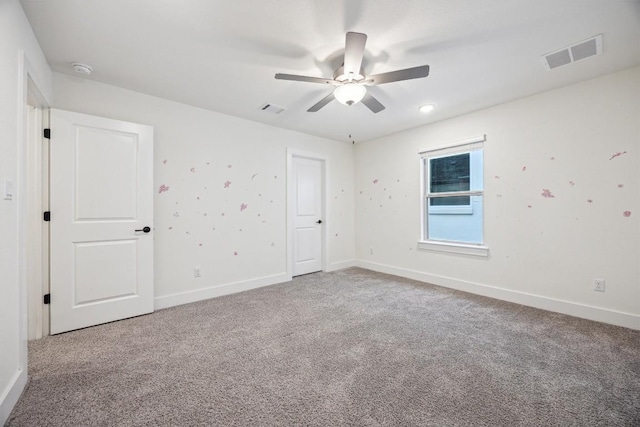 spare room featuring carpet flooring and ceiling fan