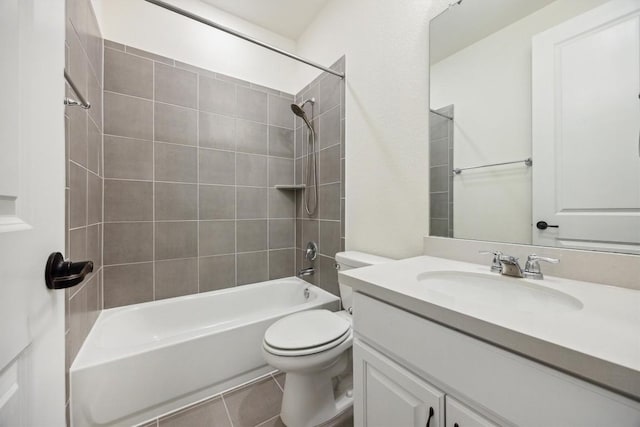 full bathroom featuring tile patterned floors, vanity, toilet, and tiled shower / bath combo