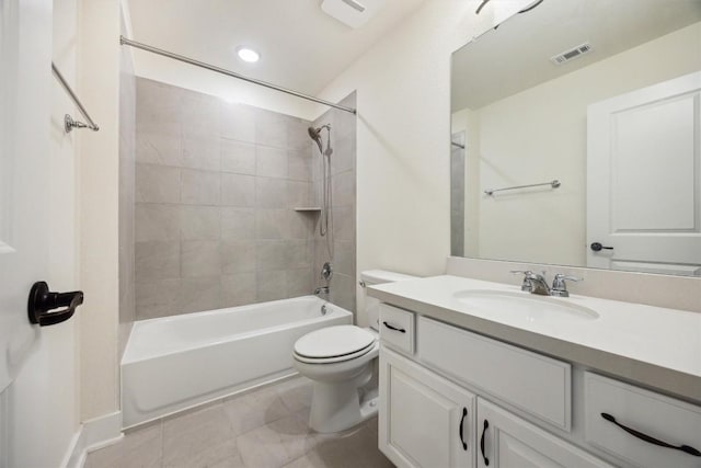 full bathroom featuring tiled shower / bath, vanity, and toilet