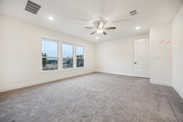 carpeted spare room with ceiling fan