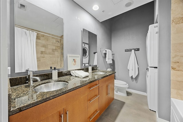 full bathroom with visible vents, stacked washer and dryer, a sink, and toilet