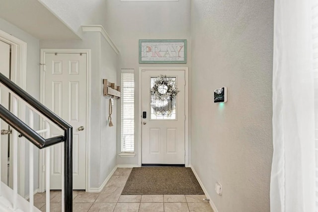 entryway with light tile patterned flooring