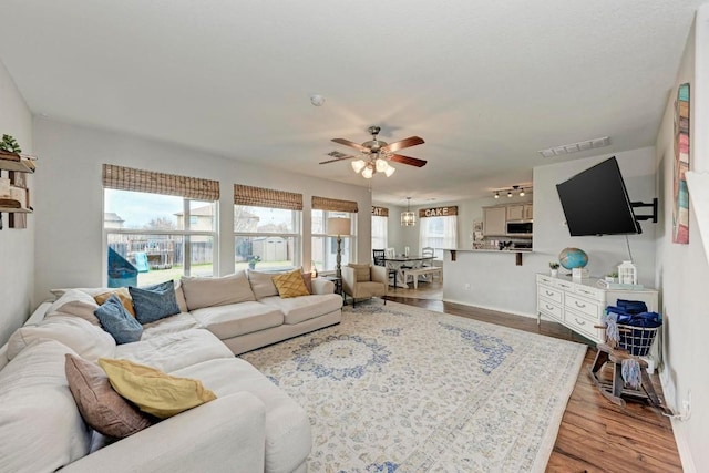 living room featuring ceiling fan and light hardwood / wood-style floors