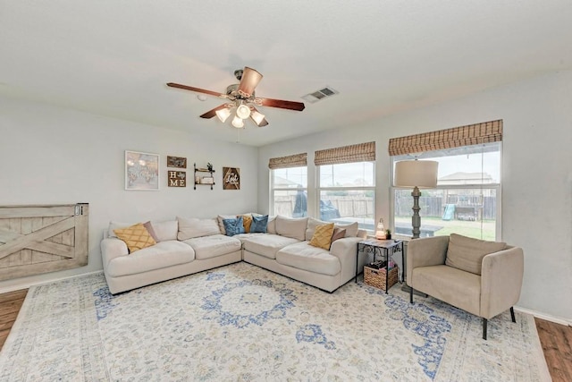 living room with hardwood / wood-style flooring and ceiling fan