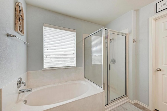 bathroom with separate shower and tub