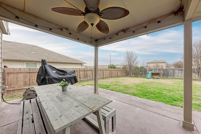 view of patio / terrace with ceiling fan and a playground