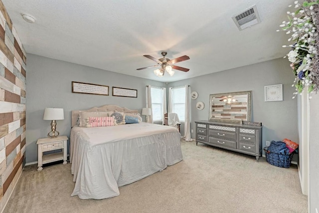 bedroom featuring light colored carpet and ceiling fan