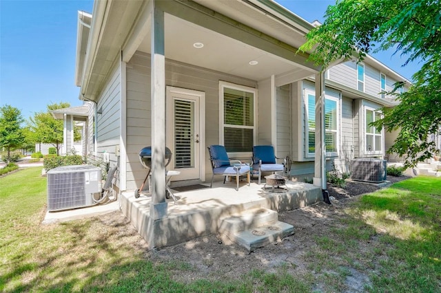 1801 Roseburg Dr Unit 29, Austin, TX 78754 - rear view of house featuring central AC, a patio area, and a lawn