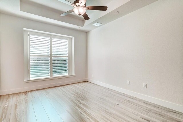1801 Roseburg Dr Unit 29, Austin, TX 78754 - unfurnished room featuring a raised ceiling, ceiling fan, and light wood-type flooring