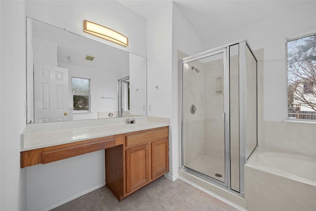 bathroom with tile patterned floors, vanity, plus walk in shower, and a wealth of natural light