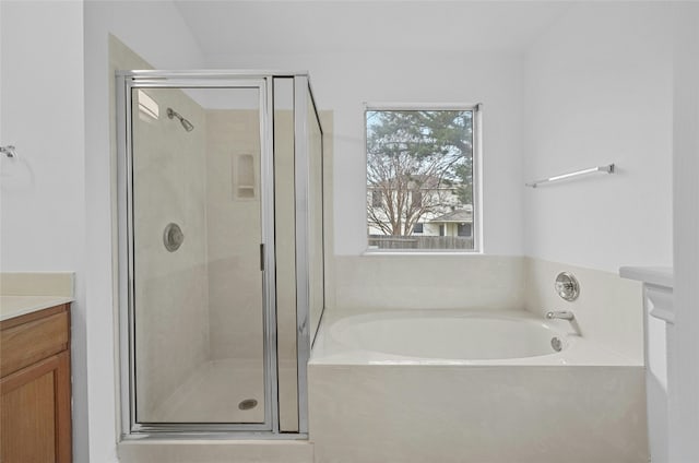 bathroom with vanity and shower with separate bathtub