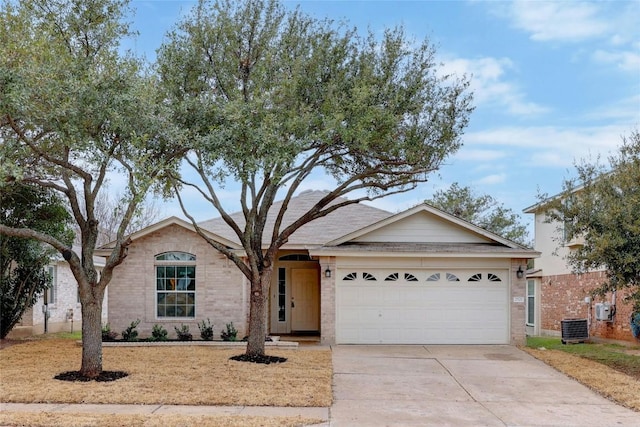 ranch-style home with cooling unit and a garage