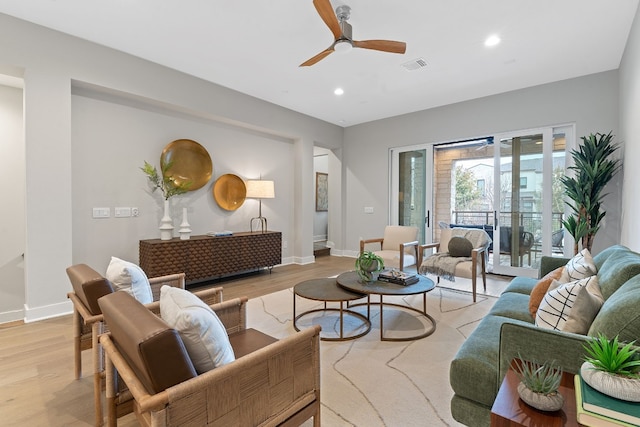 living room featuring light hardwood / wood-style flooring and ceiling fan