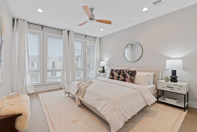 4510 Unity Cir Unit 258, Austin, TX 78731 - bedroom with multiple windows, light wood-type flooring, recessed lighting, and a ceiling fan