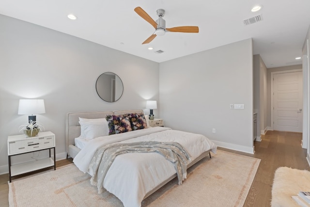 bedroom with ceiling fan and light hardwood / wood-style flooring