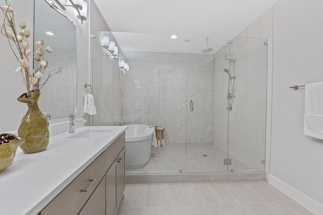 bathroom featuring vanity, shower with separate bathtub, and tile patterned flooring