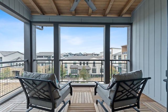 sunroom / solarium featuring wood ceiling and beam ceiling