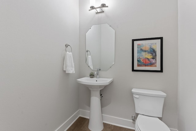 bathroom with wood-type flooring and toilet