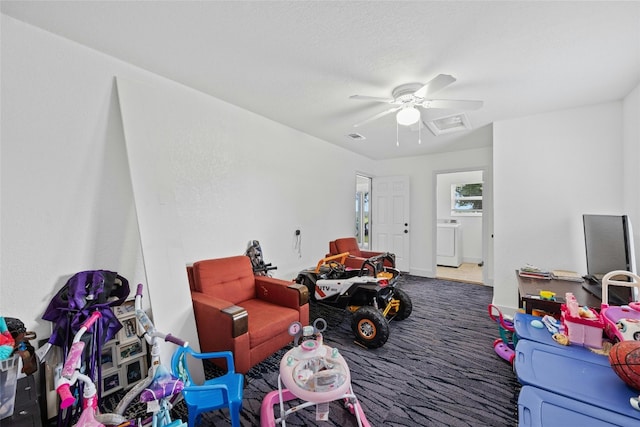 playroom featuring washer / dryer, a textured ceiling, carpet, and ceiling fan