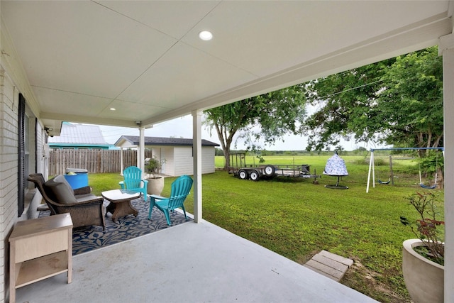 view of patio / terrace with an outdoor structure and a trampoline