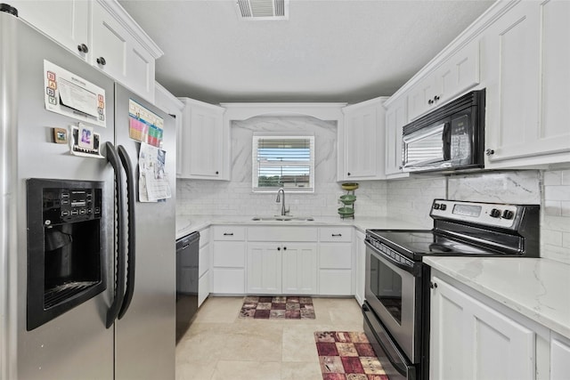 kitchen featuring white cabinetry, sink, light stone counters, and black appliances