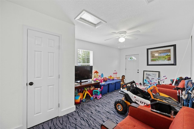 rec room with a textured ceiling and carpet