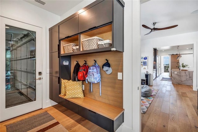 mudroom featuring a ceiling fan, wood-type flooring, and visible vents