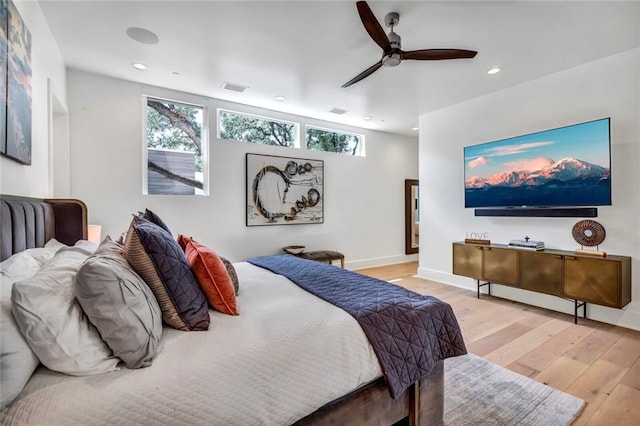 bedroom with ceiling fan and light hardwood / wood-style flooring