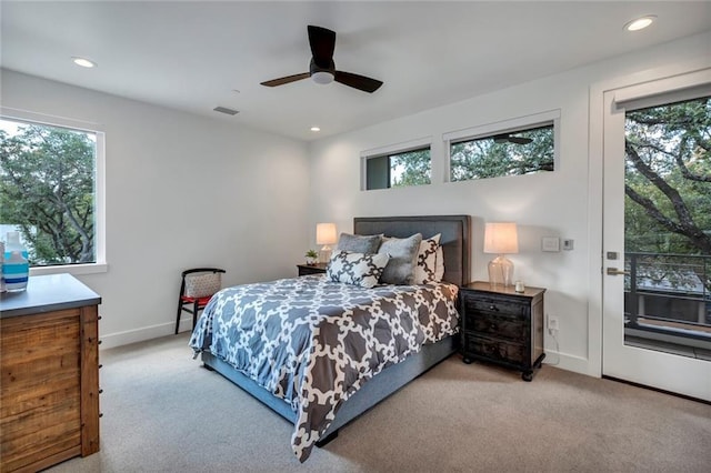 bedroom featuring multiple windows, light carpet, and ceiling fan