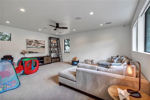 living room featuring ceiling fan and carpet flooring