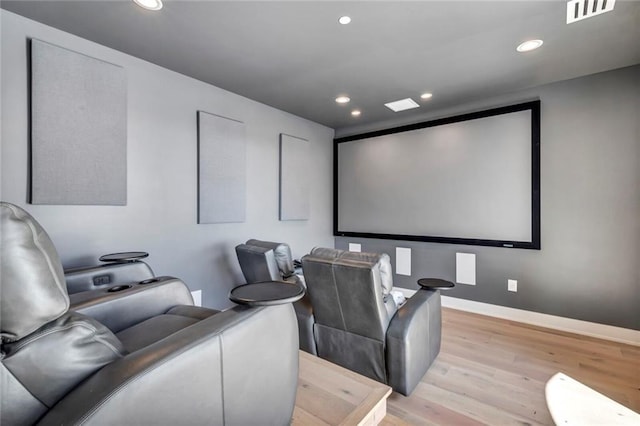 home theater featuring light wood-type flooring, baseboards, visible vents, and recessed lighting